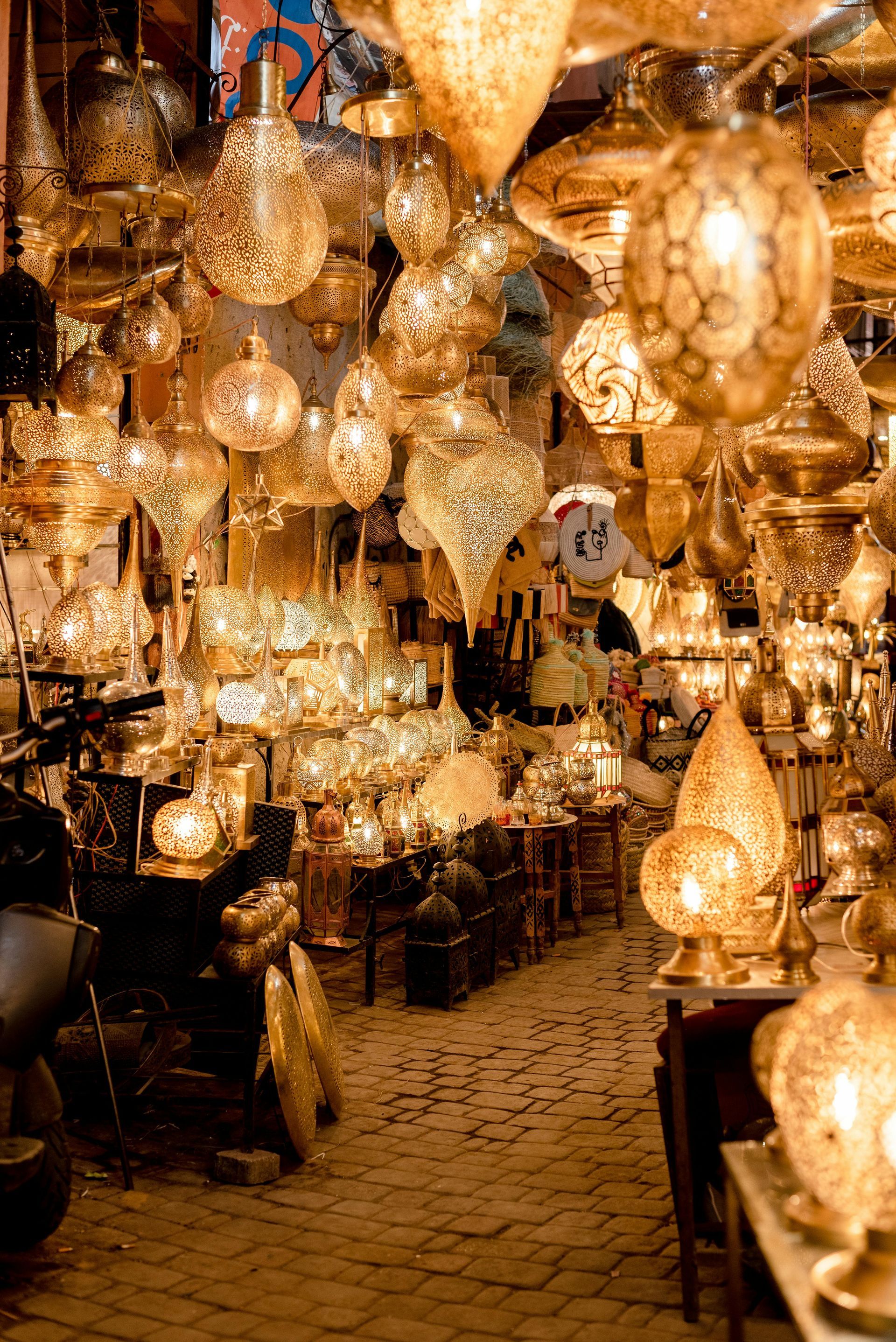 Golden, ornate lanterns fill a shop, hanging and on display, creating a warm, inviting glow. Gold Souk and old Dubai