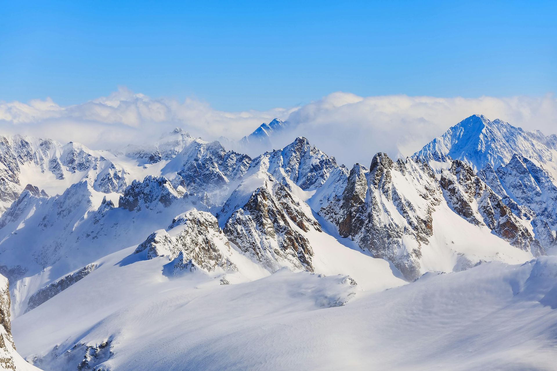 Snow-covered mountains under a clear blue sky.