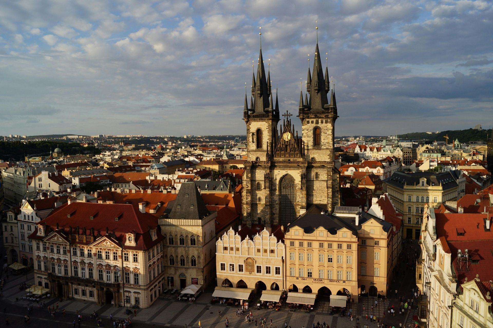 Church of Our Lady Before Týn in Prague's Old Town Square, with Gothic spires and red rooftops.