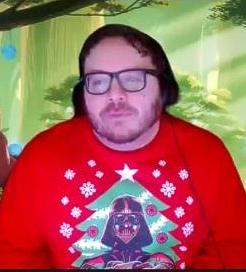 A man wearing glasses is surrounded by colorful lights.