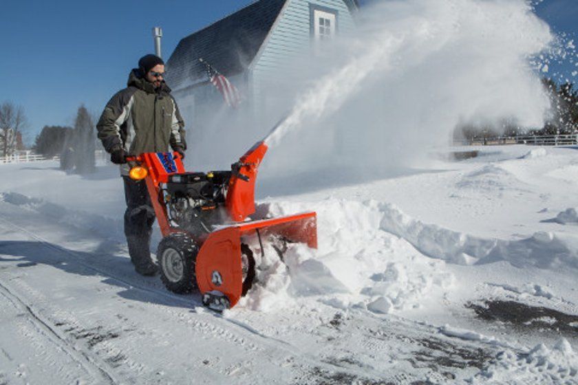 Man Removing Snow — Concord, NH — Greenlands Outdoor Power Equipment