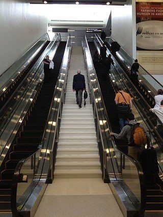 Busy escalator system with one man walking up the stairs