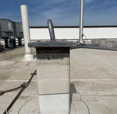 A chimney on top of a building on a roof.