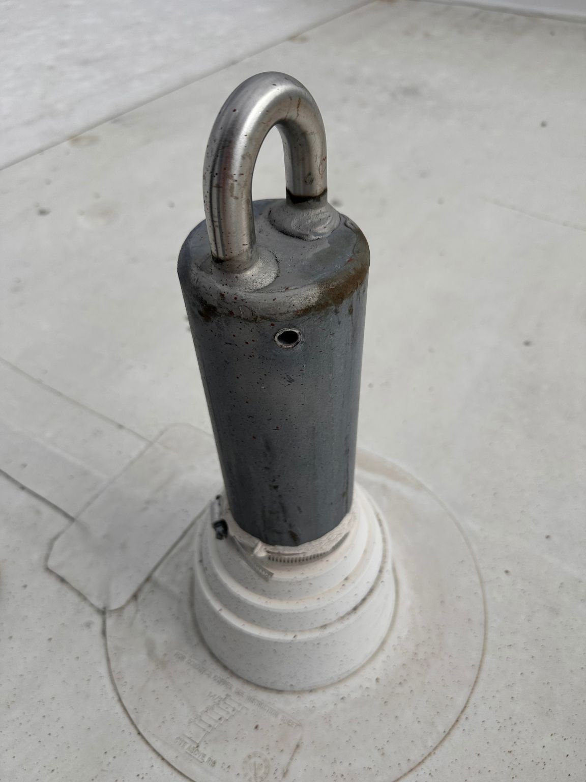A metal object with a hook on top of it