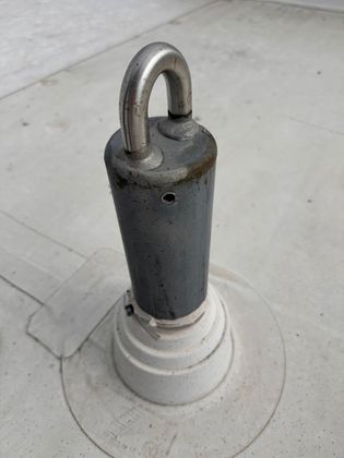 A metal object with a hook on top of it