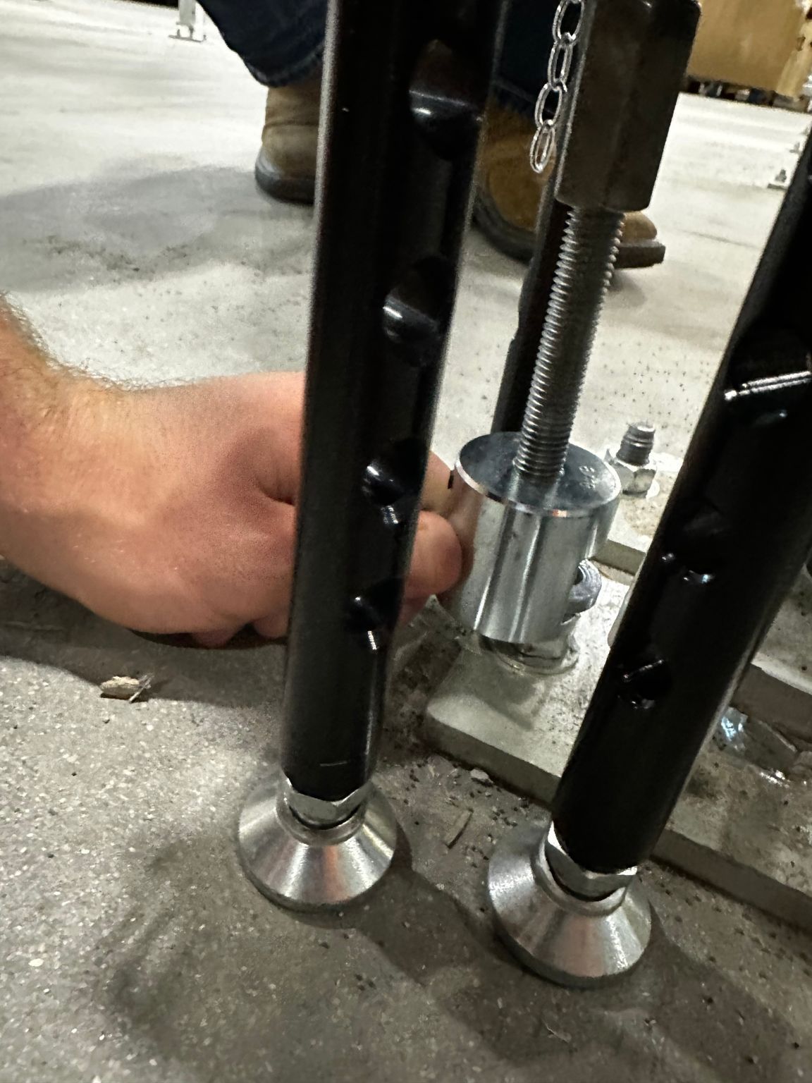 A person is working on a piece of metal on the ground.