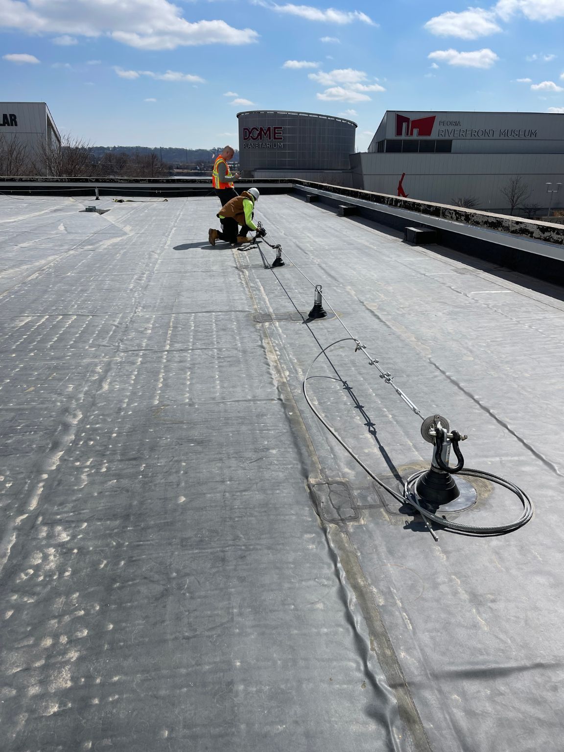 A man is working on a roof of a building.