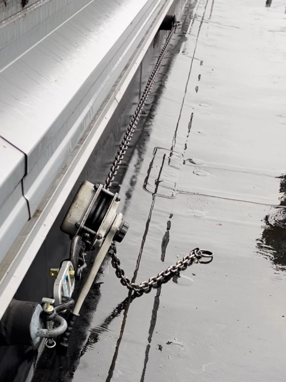 A chain is attached to the side of a boat