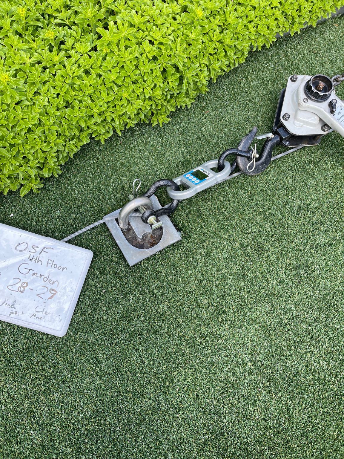 A piece of equipment is sitting on top of a lush green field.