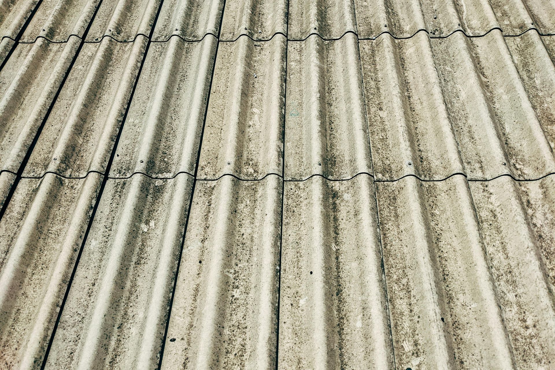 Two men are working on the roof of a building.