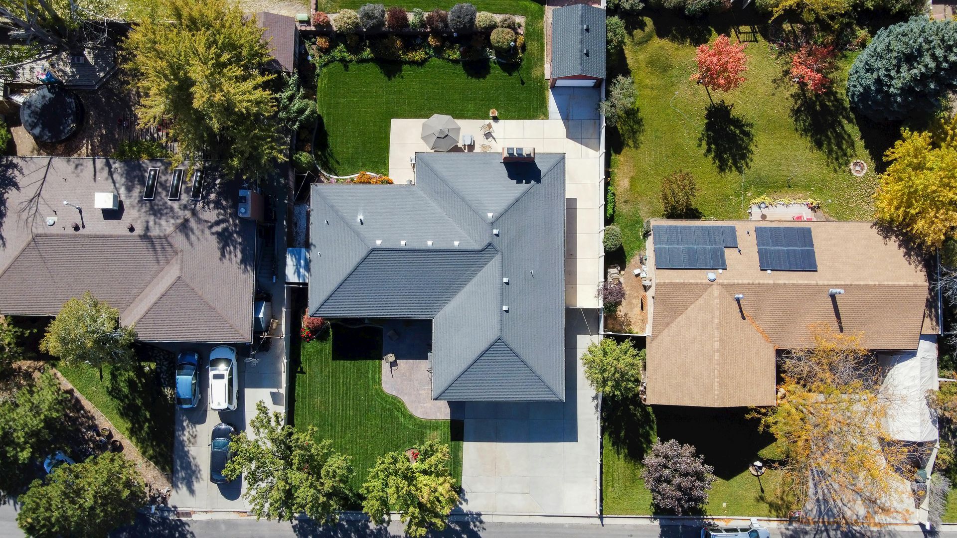 Aerial view of residential homes with green lawns and autumn trees in Upland, CA.