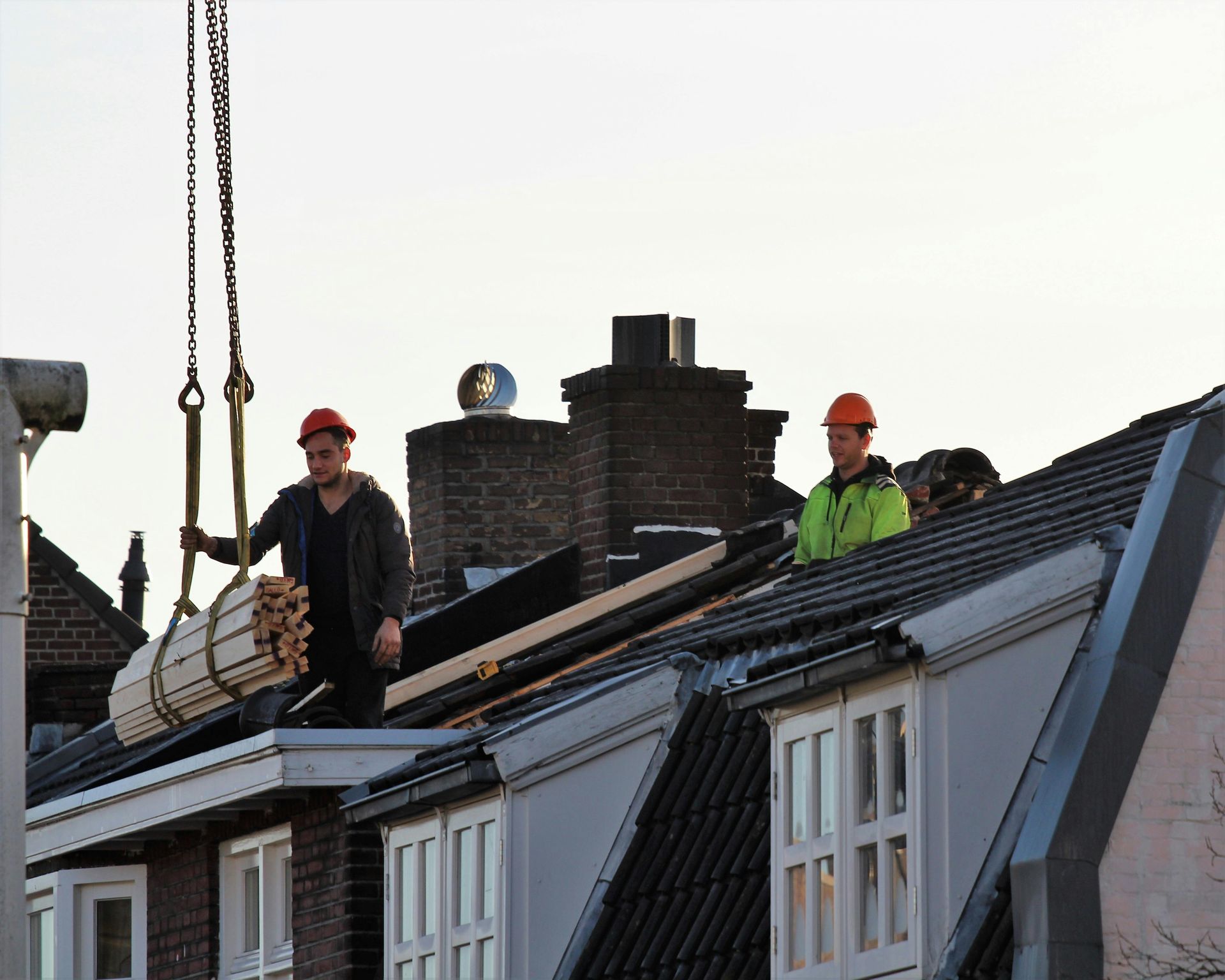 Construction workers on a roof. Vizcarra Roofing reliable roofing service in Norwalk, CA.