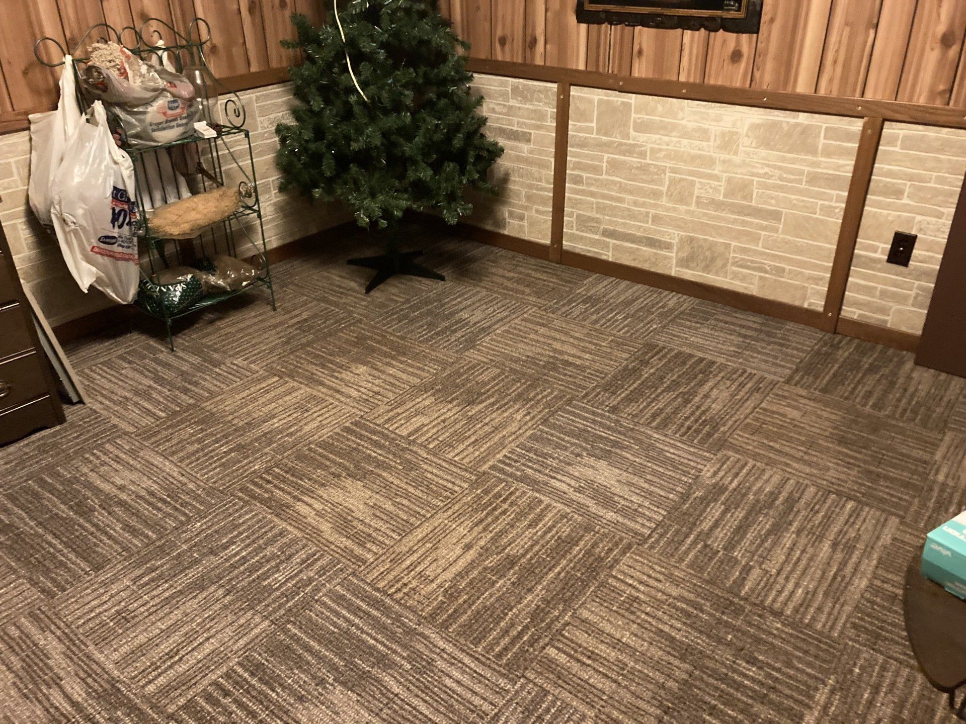 There is a christmas tree in the middle of the room.