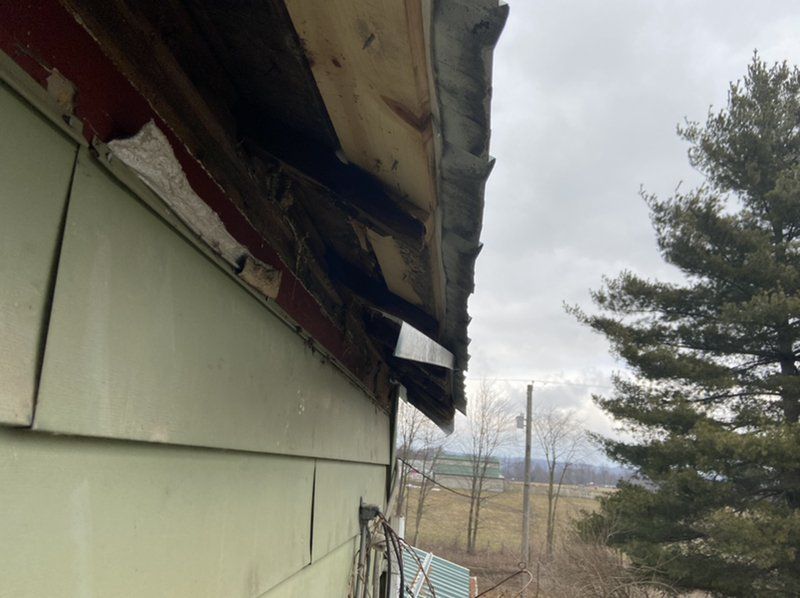 A house with a roof that has been damaged by ice dam.