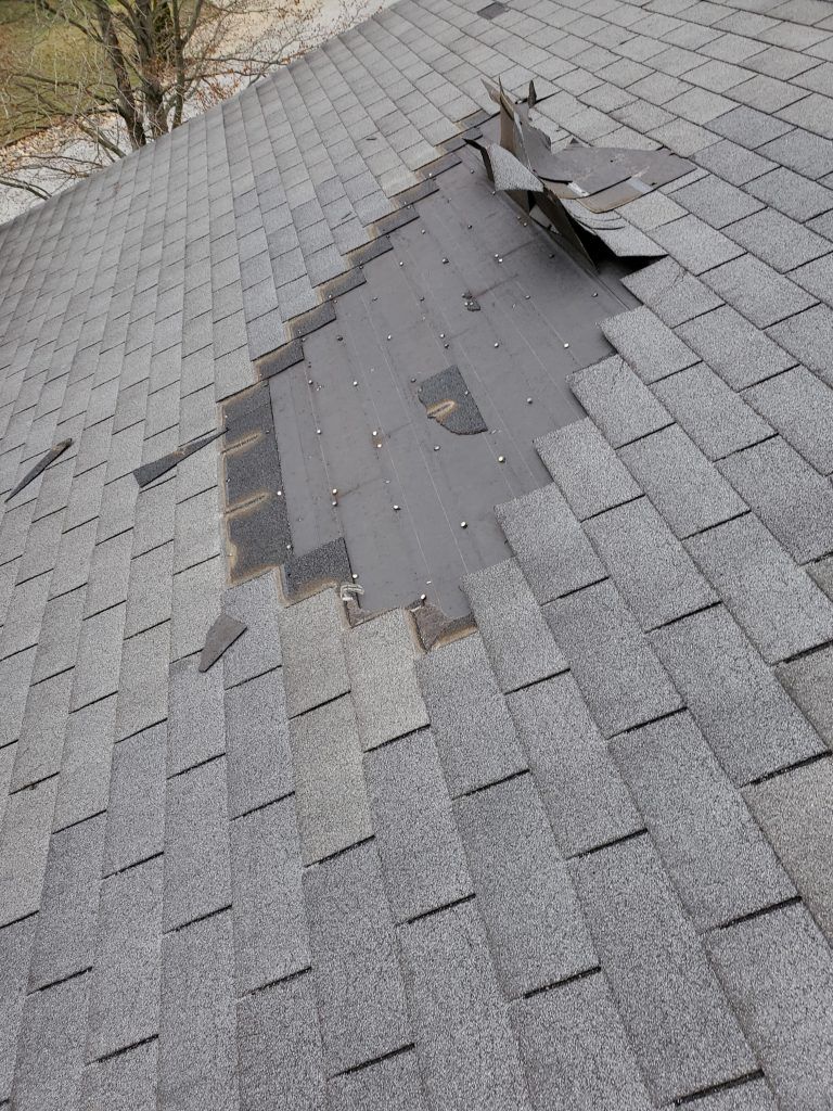 A roof with missing shingles.