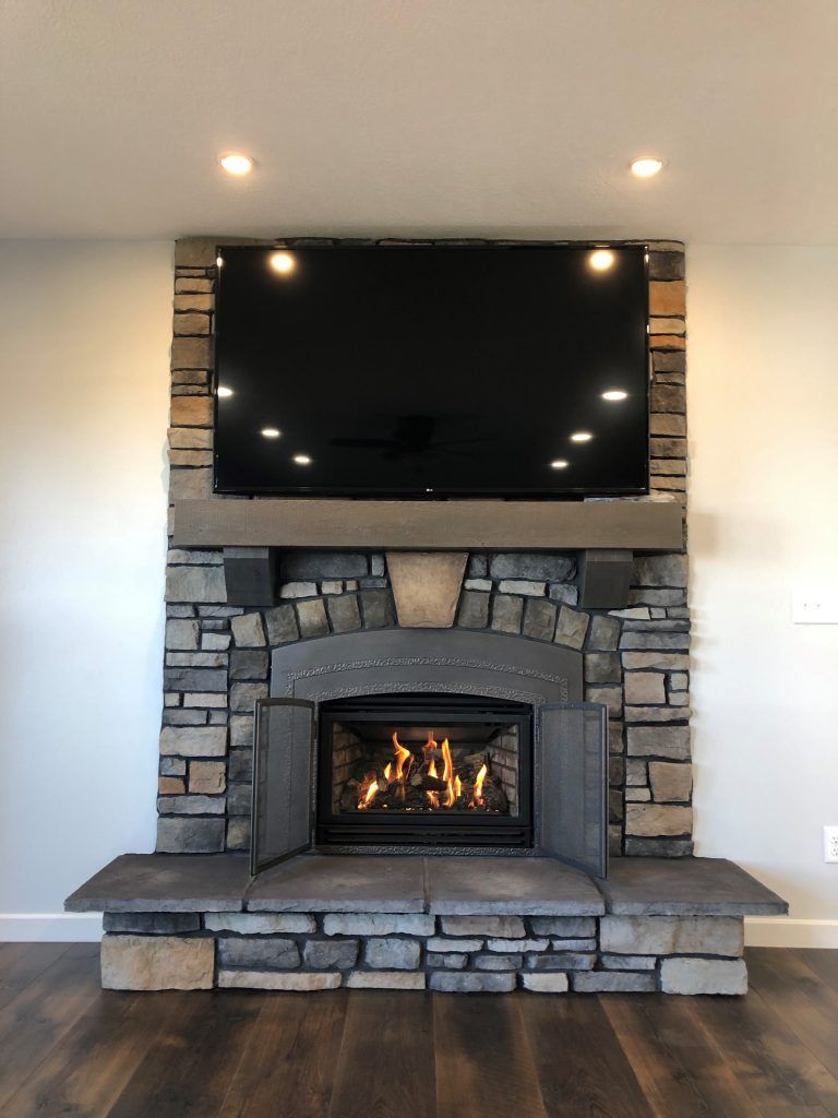 A fireplace with a flat screen tv above it