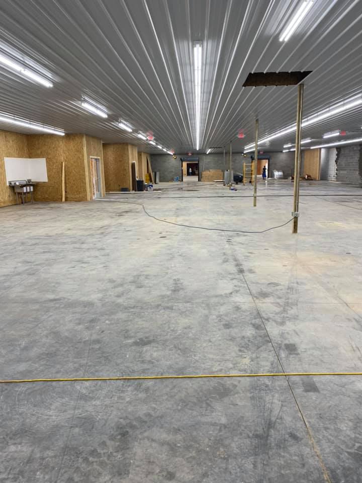 A large empty room with a metal ceiling and concrete floor.