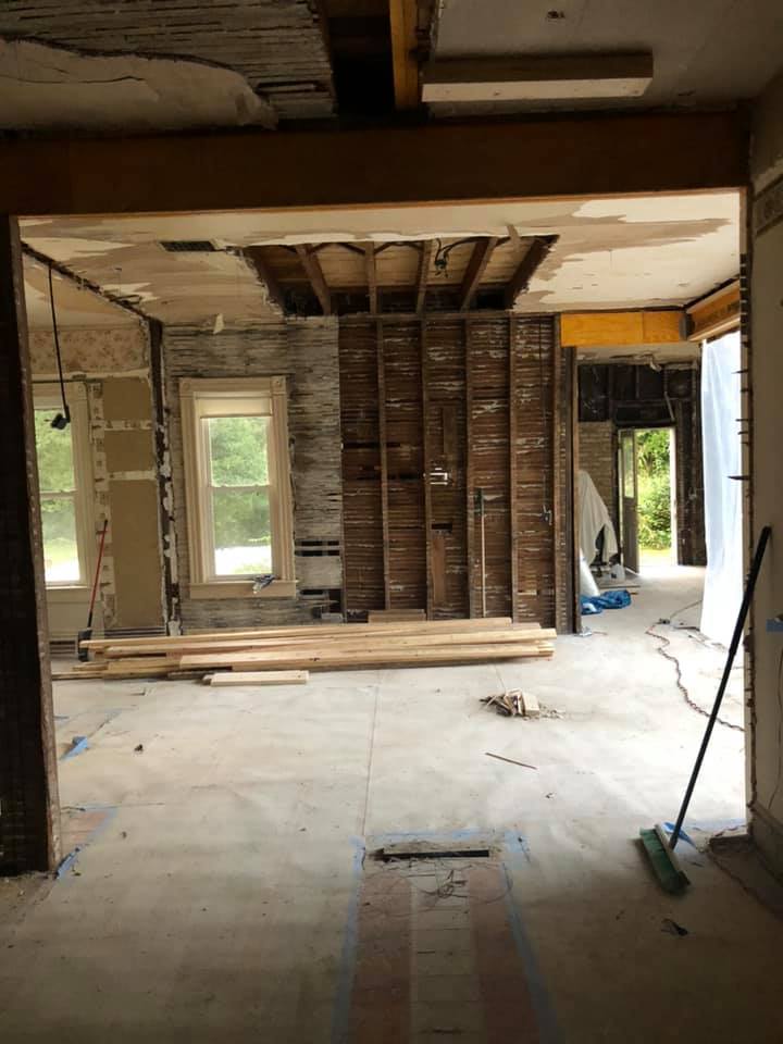 A room that is being remodeled with a pile of on the floor.