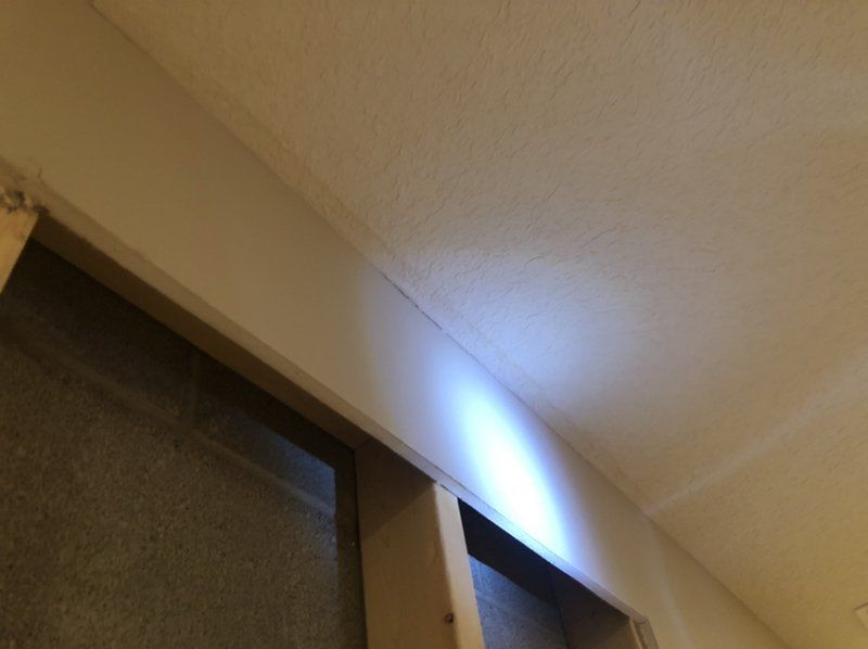 A light is shining from the ceiling of a room.