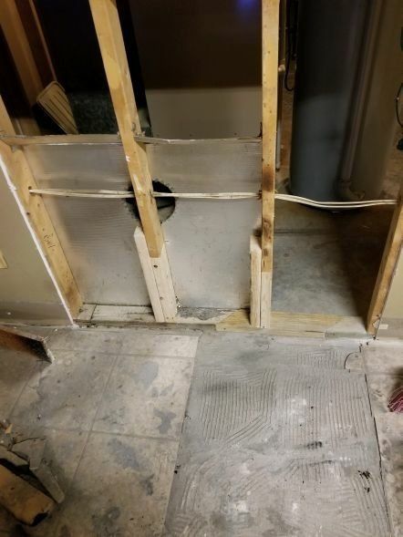 A room with a wooden frame and a concrete floor.