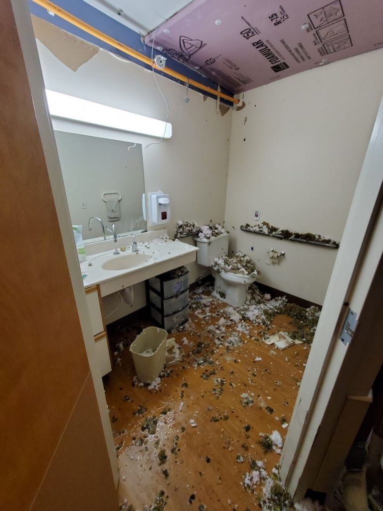 Bathroom in the building covered by debris from the above ceiling.