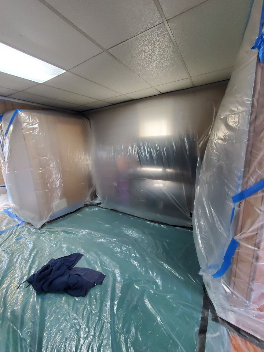 A room with a lot of plastic bags on the floor and walls.