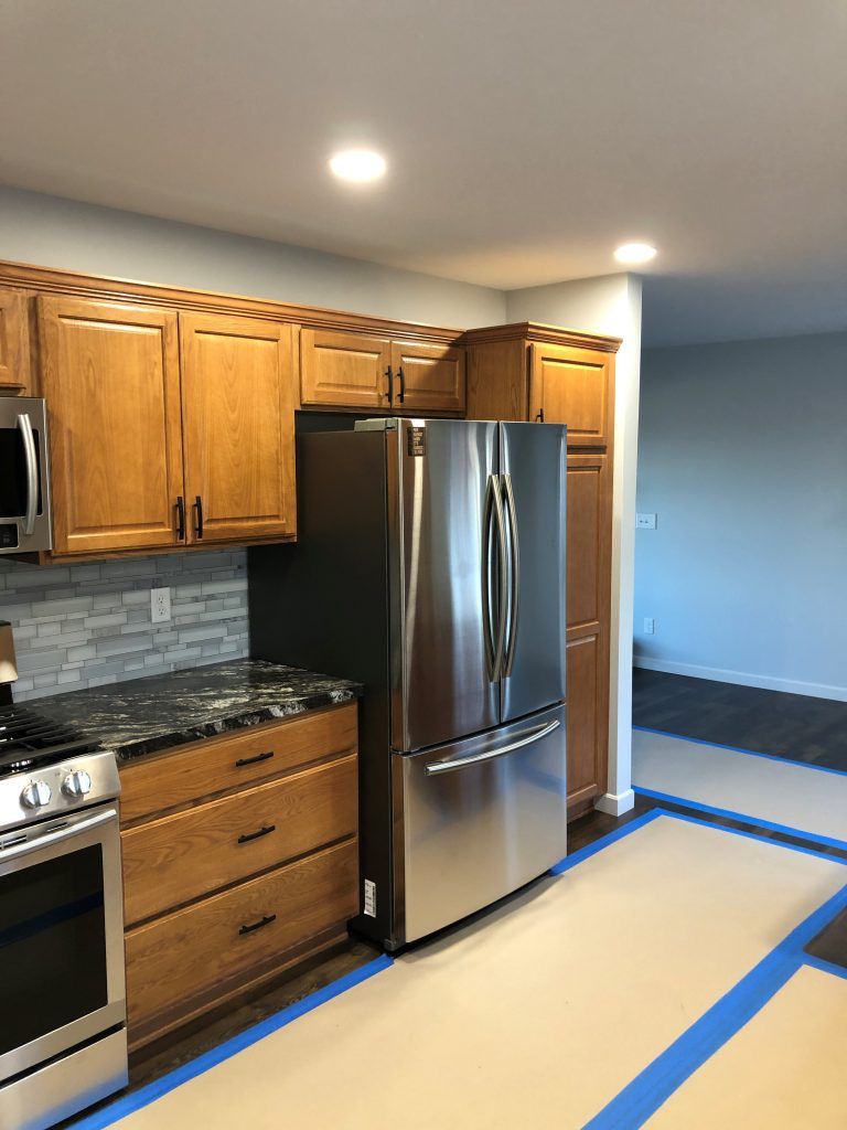 A kitchen with stainless steel appliances and wooden cabinets