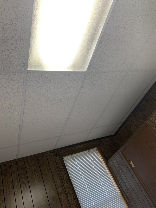 A room with a light on the ceiling and a window.