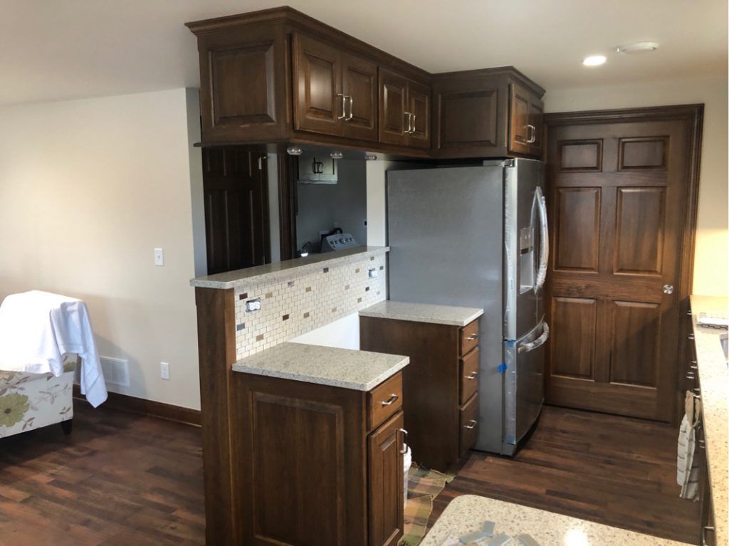 A kitchen with stainless steel appliances and wooden cabinets.