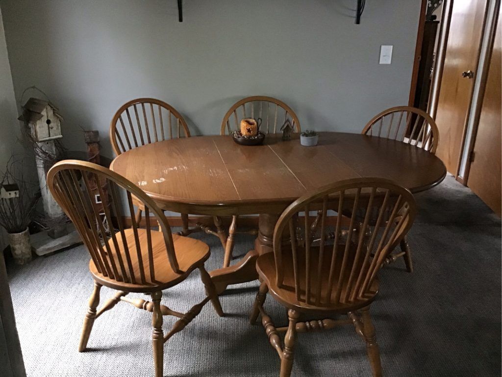 A wooden dining table and chairs in a dining room.