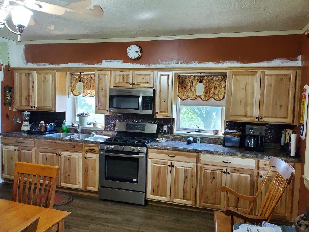 A kitchen with wooden cabinets and stainless steel appliances.