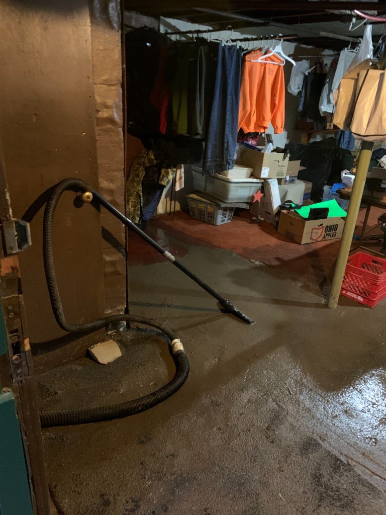 A vacuum cleaner is sitting in a flooded basement.