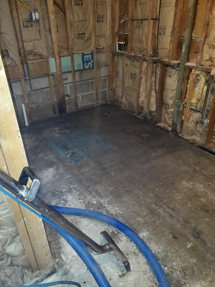 A vacuum cleaner is sitting on the floor of a room.