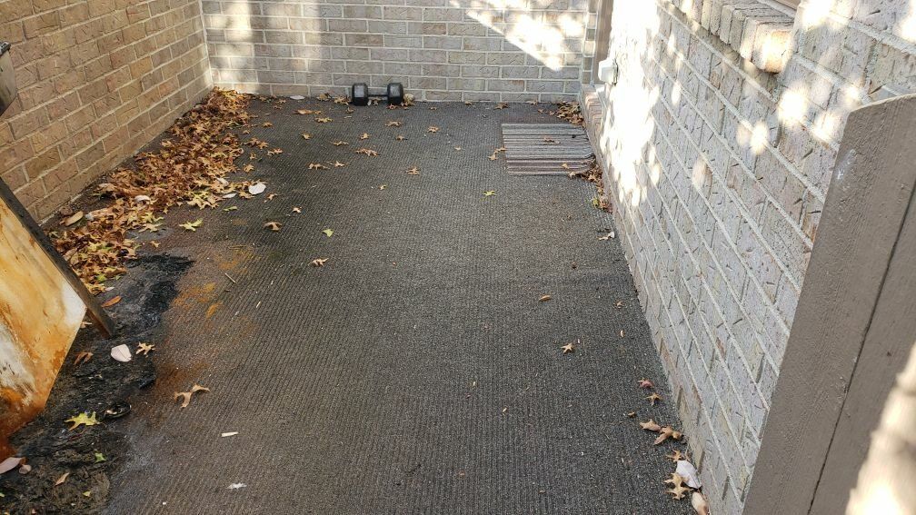 An outdoor patio with a brick wall.