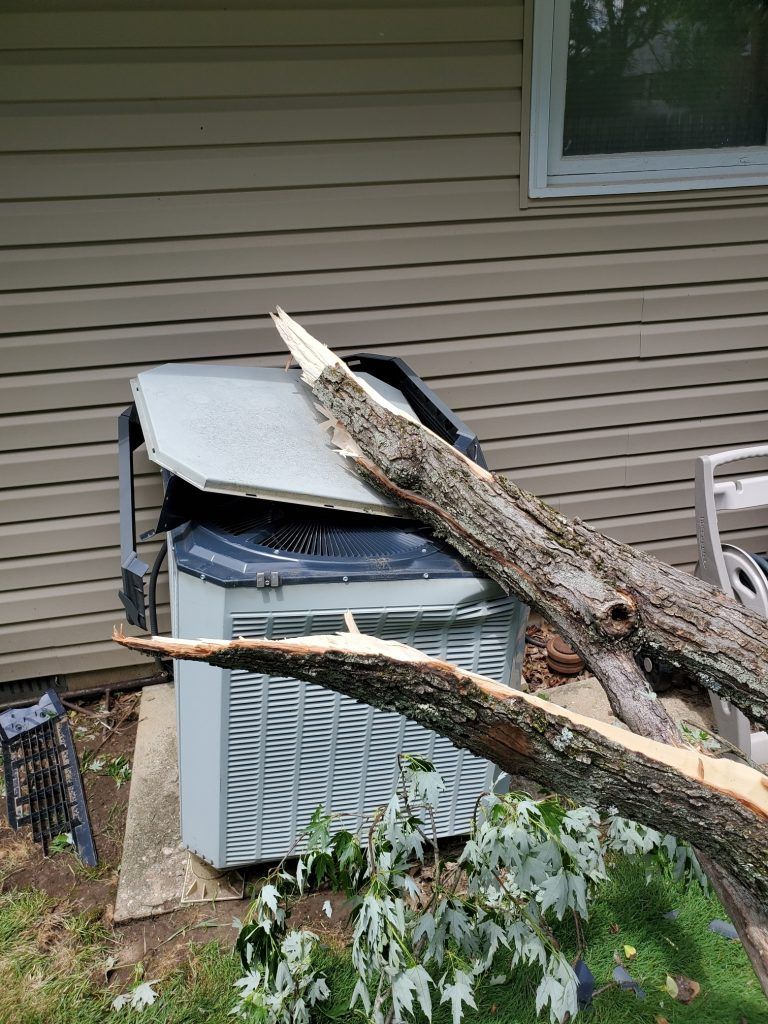 Tree fallen on outside Air Conditioning Unit.