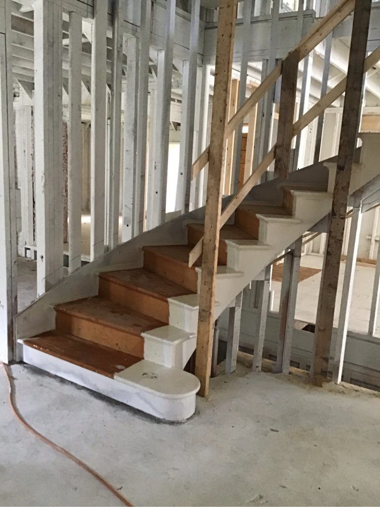 A wooden staircase in a house under construction.