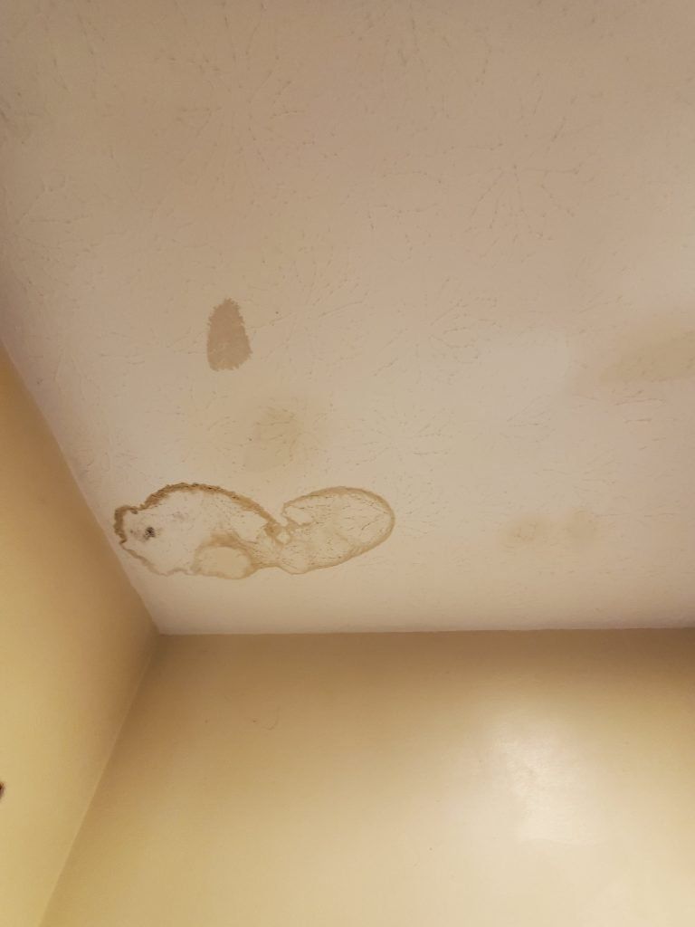 A picture of a ceiling with water damage.