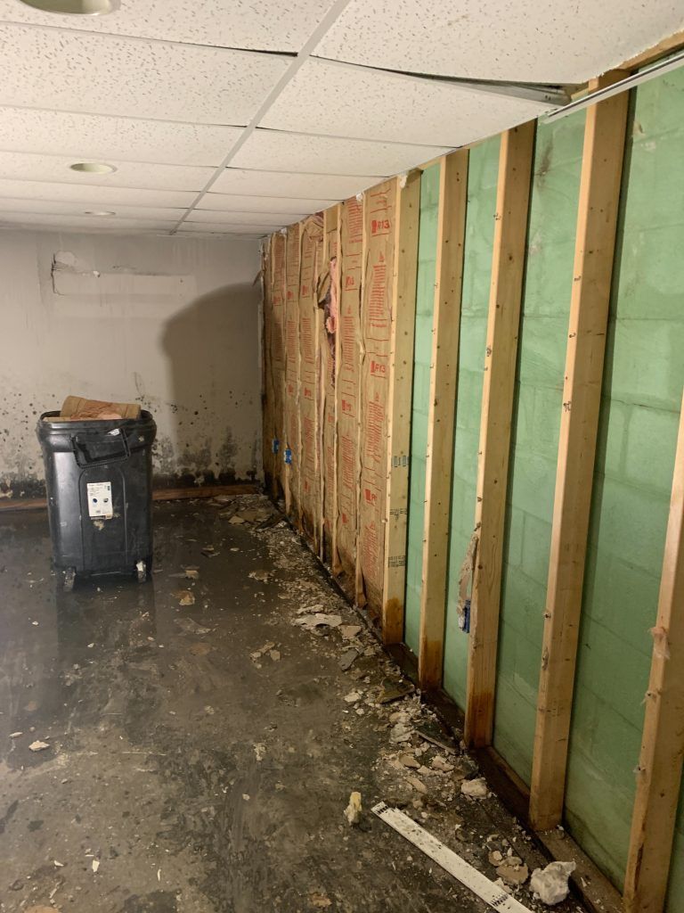 There is a trash can in the middle of the room.