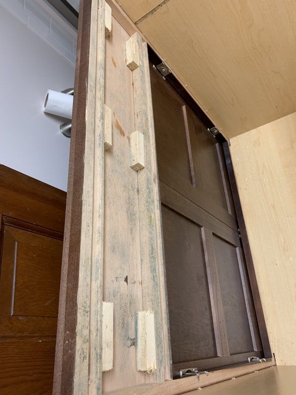 A piece of wood is sitting on top of a wooden door.