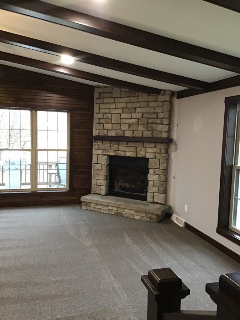 There is a fireplace in the corner of the room.