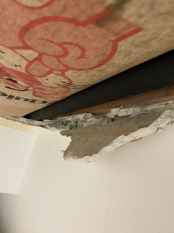 A close up of a ceiling with a hole in it.