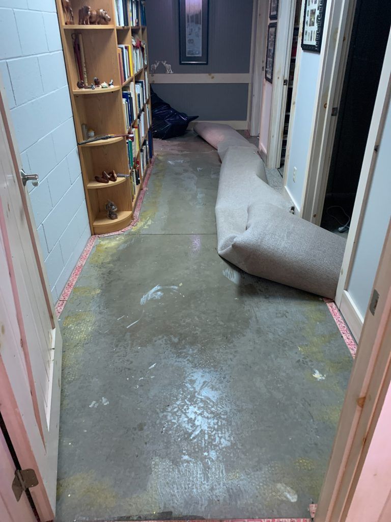 A carpet is laying on the floor in a hallway.