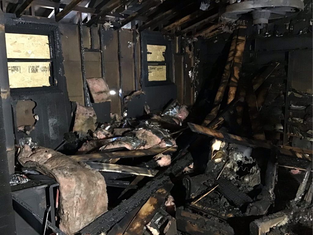 A room full of rubble that has been destroyed by a fire. 