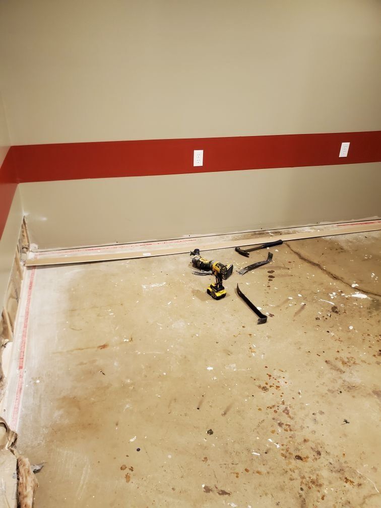 A room that is being repaired with tools on the floor.