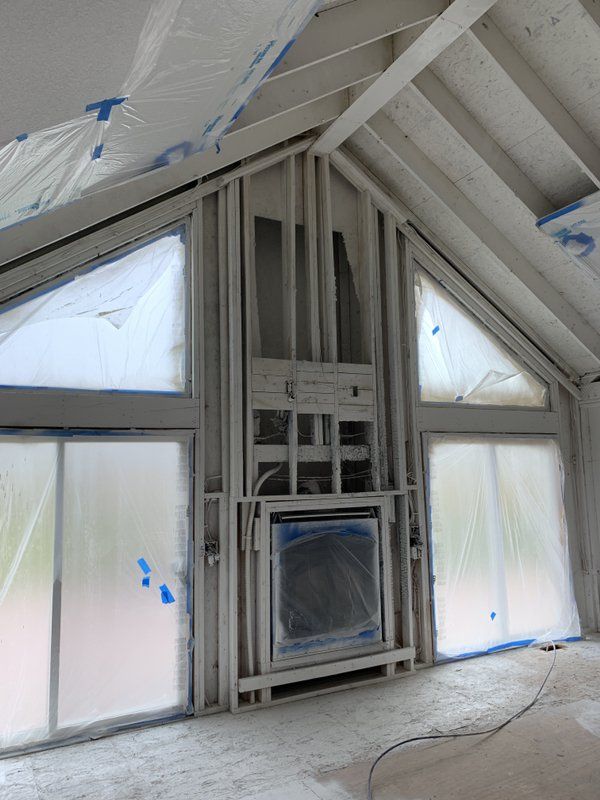 A room with a fireplace and a lot of windows.