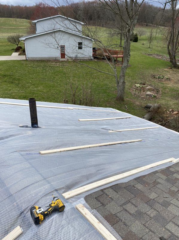 A roof that was damaged and is now being repaired.