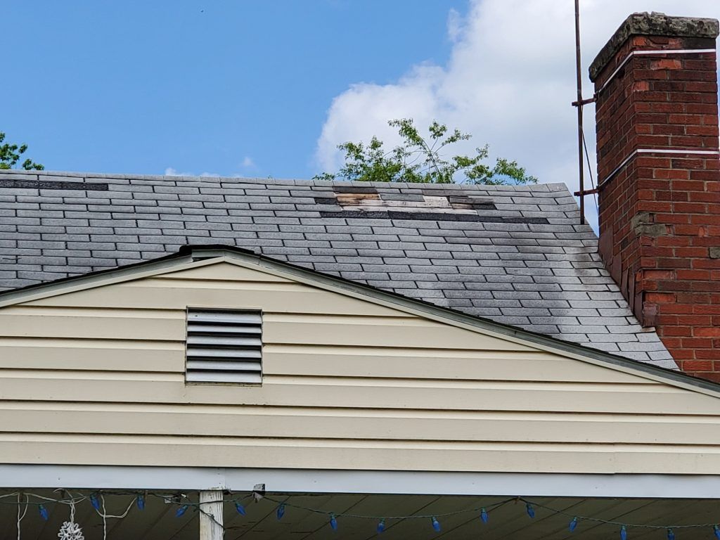 A damaged roof with chimney.
