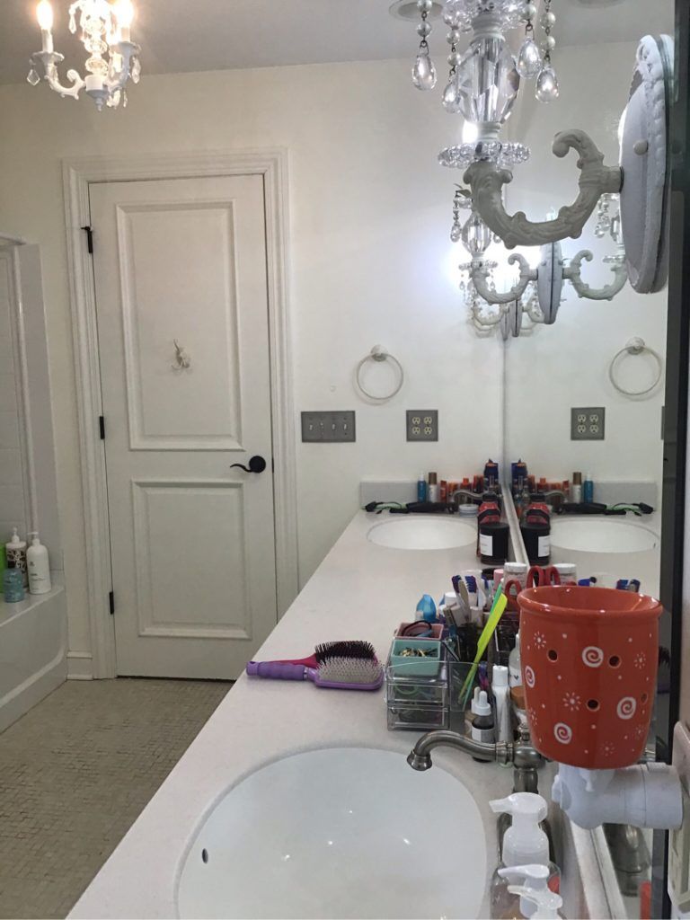 A bathroom with two sinks and a large mirror.