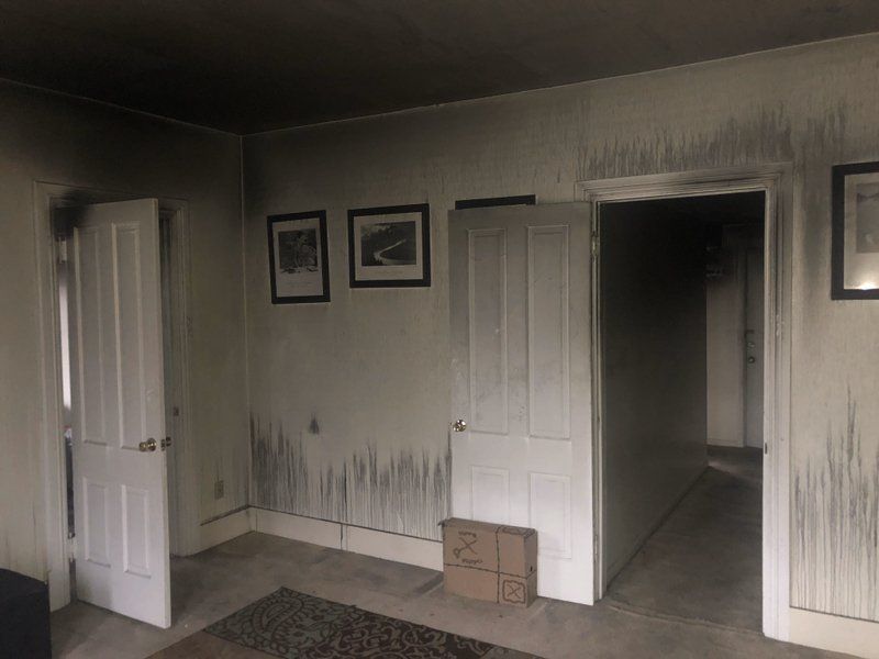 A room with a lot of doors and pictures on the wall.