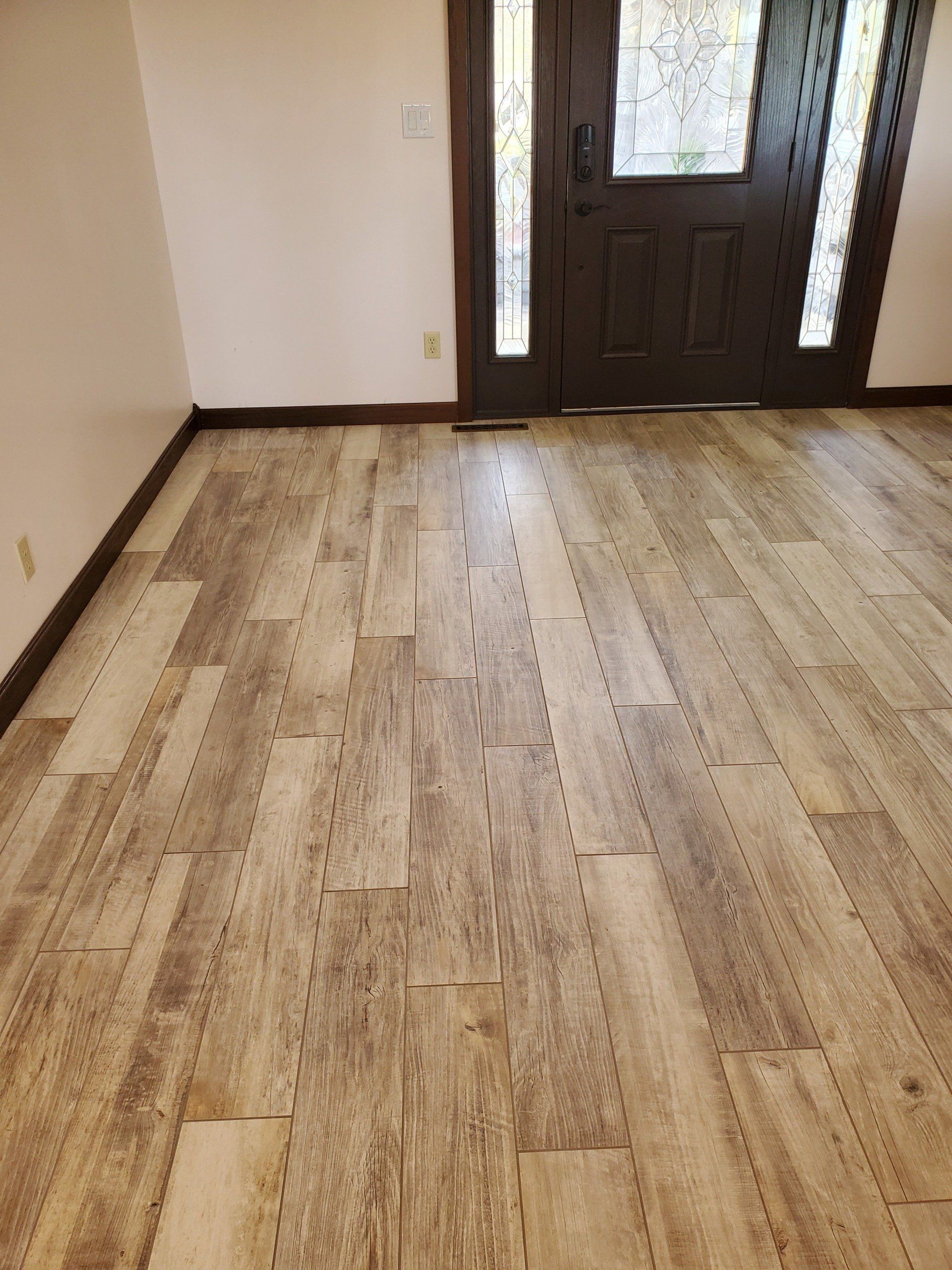 A room with a wooden floor and a door.